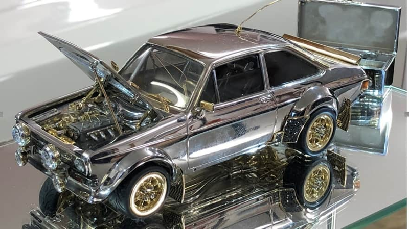 Illustration for article titled I Am So Here for This Tiny Ford Escort Model Made of $90,000 in Silver, Gold and Diamonds